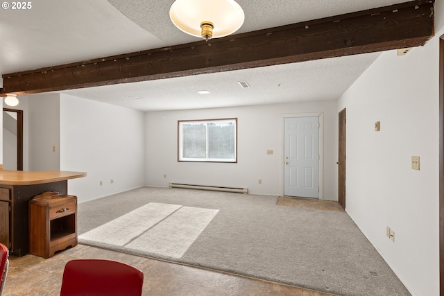 1521 Ranch Rd, Reedsport, OR 97467 - unfurnished living room featuring light carpet, a baseboard heating unit, beam ceiling, and a textured ceiling