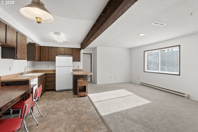 1521 Ranch Rd, Reedsport, OR 97467 - kitchen with white appliances, a sink, a baseboard radiator, dark brown cabinetry, and light colored carpet