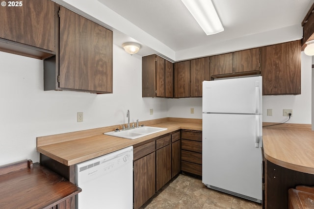 1521 Ranch Rd, Reedsport, OR 97467 - kitchen featuring white appliances, a sink, light countertops, and dark brown cabinetry
