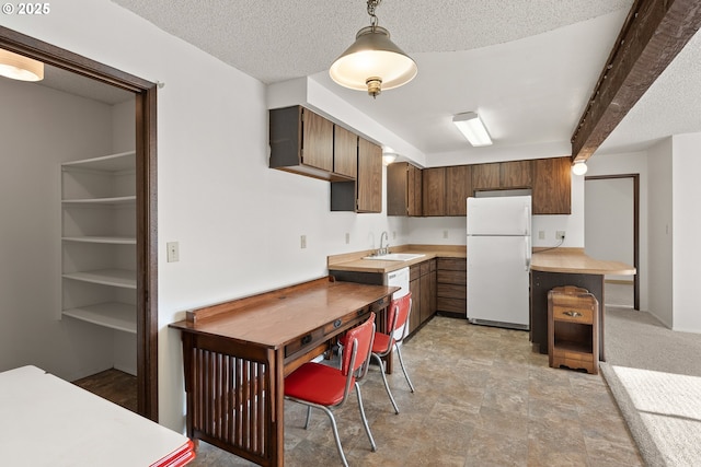 1521 Ranch Rd, Reedsport, OR 97467 - kitchen with white appliances, a sink, light countertops, decorative light fixtures, and beam ceiling
