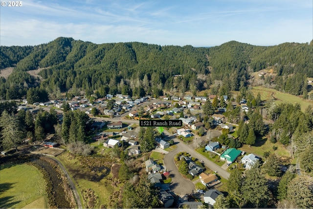 1521 Ranch Rd, Reedsport, OR 97467 - aerial view of property and surrounding area with a forest and nearby suburban area