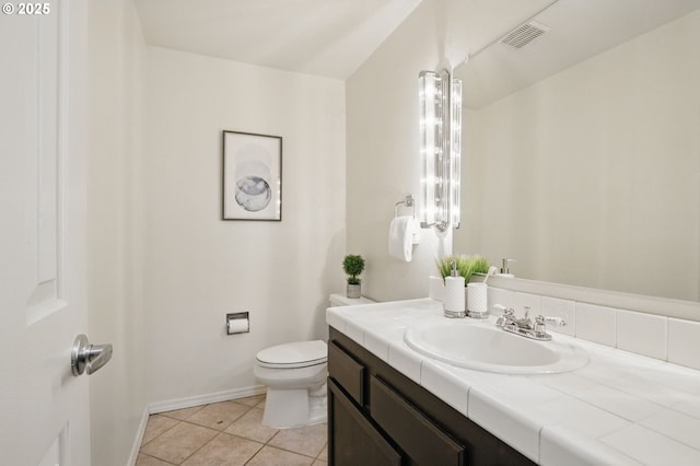 bathroom featuring tile patterned floors, visible vents, toilet, baseboards, and vanity