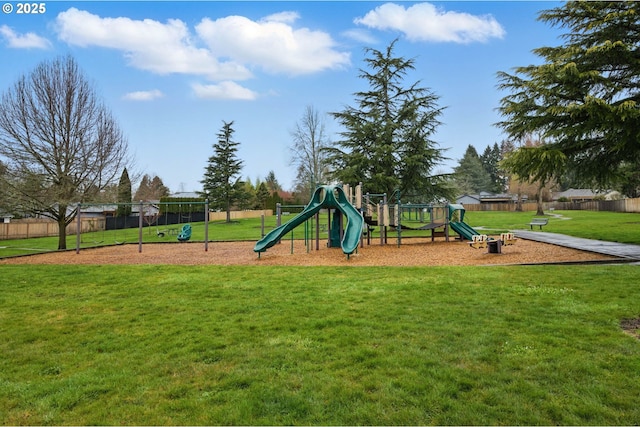 community jungle gym with a lawn and fence