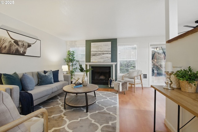 29460 SW Volley St Unit 67, Wilsonville, OR 97070 - living room featuring wood finished floors and a fireplace with flush hearth