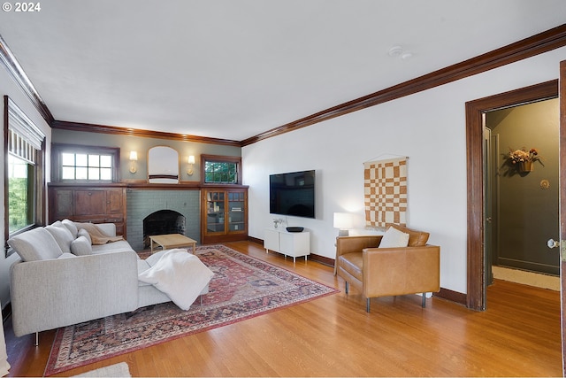 7516 N Brandon Ave, Portland, OR 97217 - living room with a fireplace, wood finished floors, plenty of natural light, crown molding, and baseboards