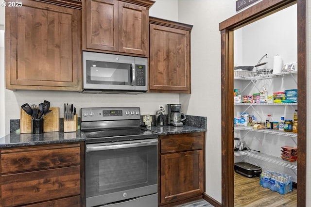 445 Hatfield Dr, Roseburg, OR 97470 - kitchen with appliances with stainless steel finishes, wood finished floors, and dark stone counters