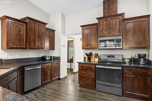 445 Hatfield Dr, Roseburg, OR 97470 - kitchen featuring stainless steel appliances, dark wood-style flooring, dark stone counters, and dark brown cabinetry