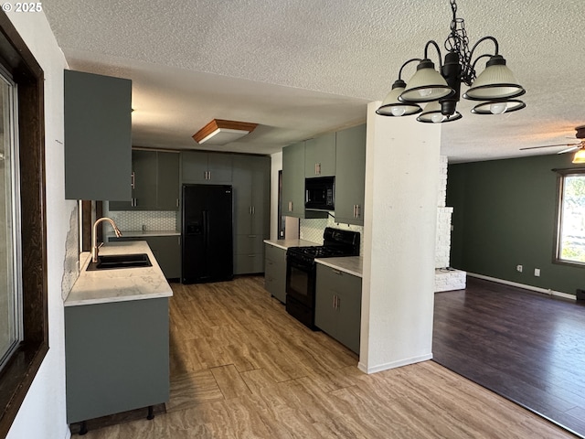 404 NE High St, Goldendale, WA 98620 - kitchen featuring a sink, black appliances, a textured ceiling, wood finished floors, and ceiling fan
