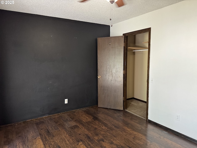404 NE High St, Goldendale, WA 98620 - unfurnished bedroom featuring wood finished floors, a closet, a textured ceiling, baseboards, and a ceiling fan