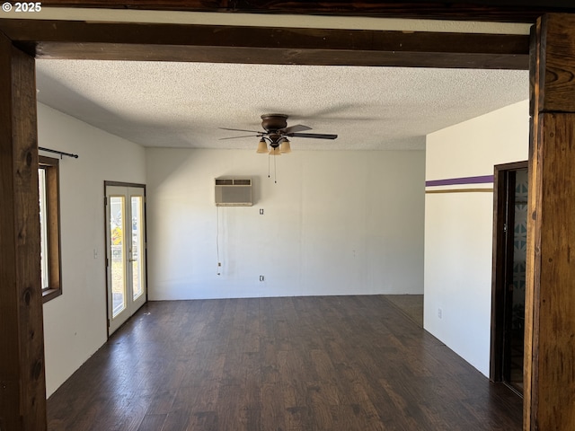 404 NE High St, Goldendale, WA 98620 - spare room featuring a wall mounted AC, dark wood-type flooring, a ceiling fan, and a textured ceiling