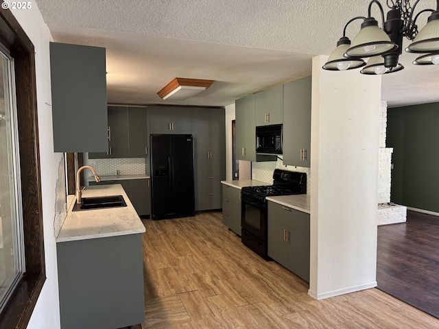 404 NE High St, Goldendale, WA 98620 - kitchen featuring black appliances, a sink, light countertops, light wood-type flooring, and tasteful backsplash