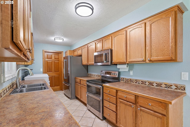 16880 Tracy Ave, Lake Oswego, OR 97035 - kitchen with stainless steel appliances, a textured ceiling, and light tile patterned flooring
