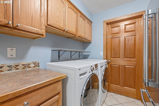 16880 Tracy Ave, Lake Oswego, OR 97035 - washroom with cabinet space, washer and dryer, and light tile patterned floors