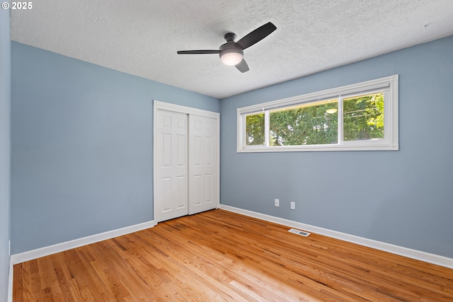 16880 Tracy Ave, Lake Oswego, OR 97035 - unfurnished bedroom with a textured ceiling, wood finished floors, a closet, and a ceiling fan