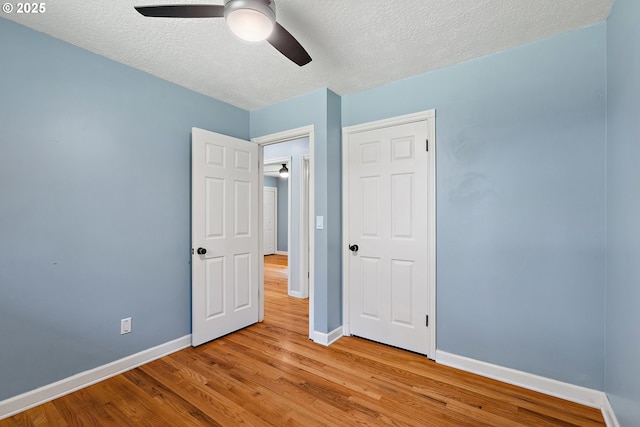 16880 Tracy Ave, Lake Oswego, OR 97035 - unfurnished bedroom featuring wood finished floors, a textured ceiling, and a ceiling fan