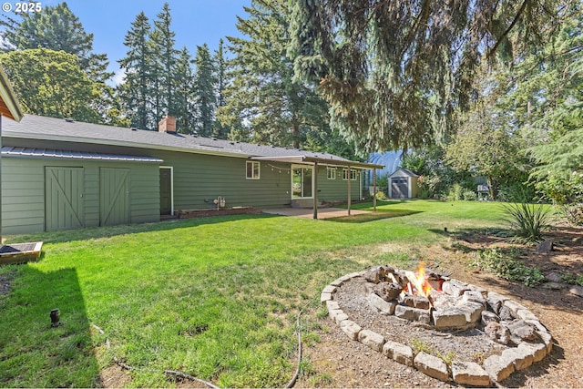 16880 Tracy Ave, Lake Oswego, OR 97035 - view of grassy yard with a shed, an outdoor fire pit, and a patio area
