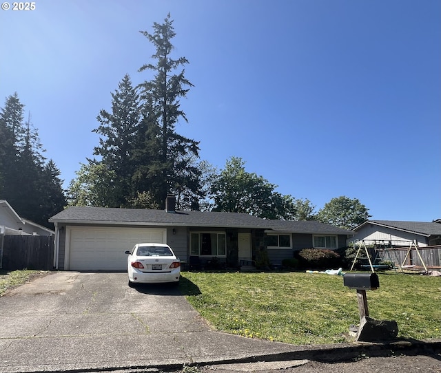 ranch-style home with fence, an attached garage, a front yard, and aphalt driveway