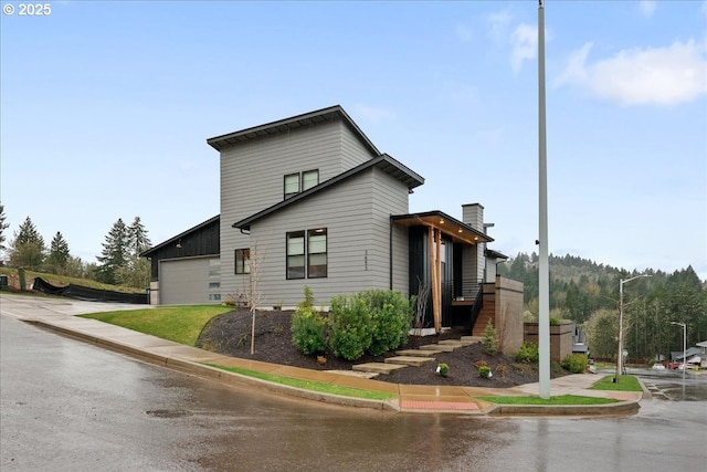 3653 Maidenhair Pl S, Salem, OR 97302 - view of side of home featuring board and batten siding, an attached garage, driveway, and a chimney