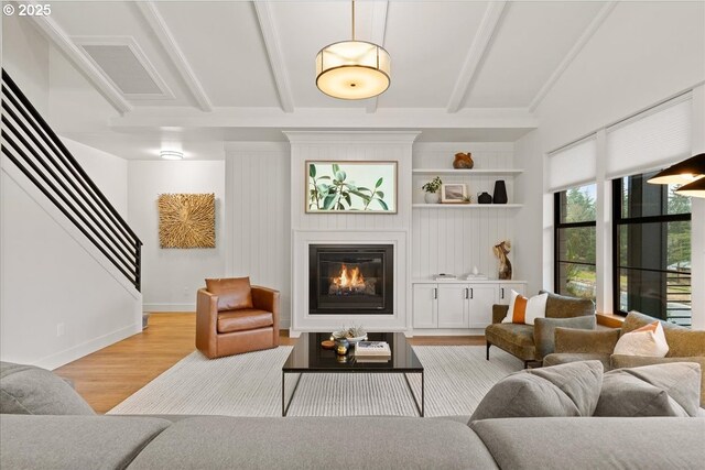 3653 Maidenhair Pl S, Salem, OR 97302 - living area featuring beamed ceiling, visible vents, a large fireplace, and light wood-style floors