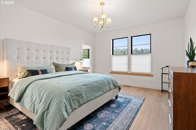 3653 Maidenhair Pl S, Salem, OR 97302 - bedroom featuring baseboards, an inviting chandelier, and light wood-type flooring