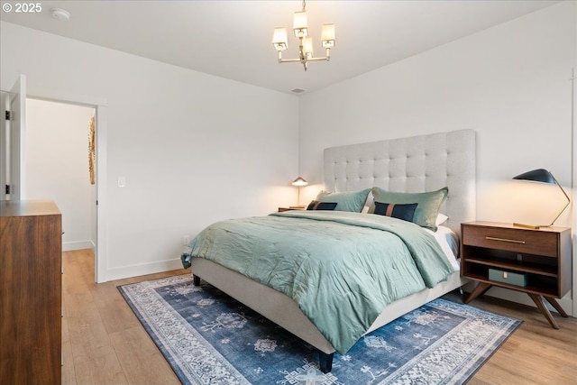 3653 Maidenhair Pl S, Salem, OR 97302 - bedroom with baseboards, a notable chandelier, and wood finished floors