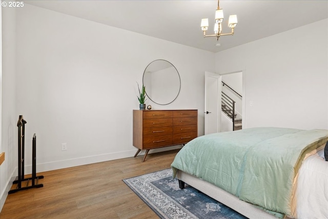 3653 Maidenhair Pl S, Salem, OR 97302 - bedroom featuring baseboards, wood finished floors, and a notable chandelier