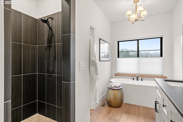 3653 Maidenhair Pl S, Salem, OR 97302 - full bath featuring wood finished floors, a freestanding tub, an inviting chandelier, a tile shower, and visible vents