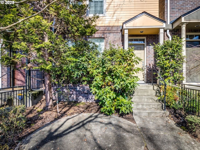 doorway to property with brick siding