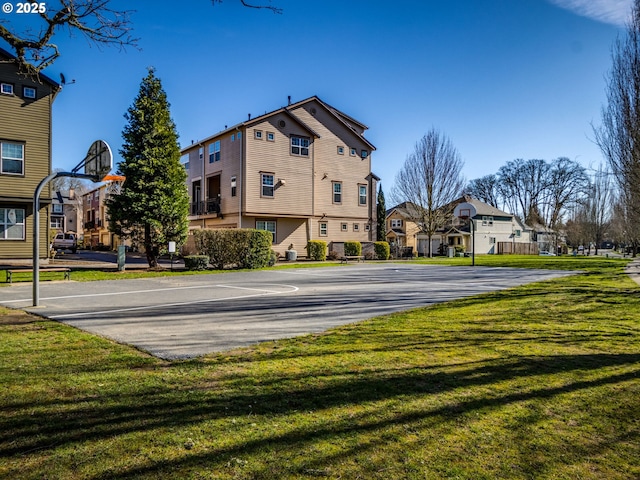 view of sport court with community basketball court, a yard, and a residential view