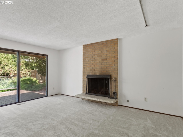 unfurnished living room with carpet floors, a textured ceiling, visible vents, and a fireplace