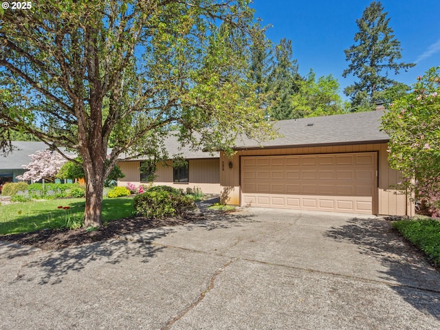 single story home with a garage and driveway