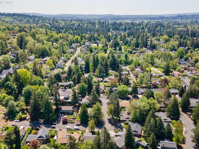 aerial view with a wooded view and a residential view