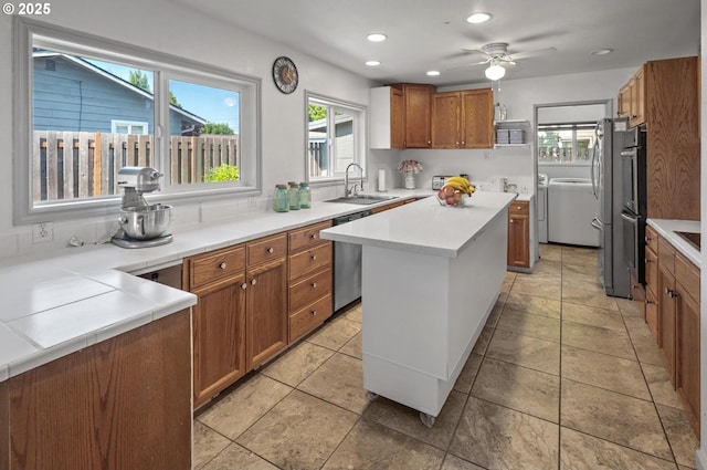 52396 SW 2nd St, Scappoose, OR 97056 - kitchen with a sink, stainless steel appliances, brown cabinets, recessed lighting, and light countertops