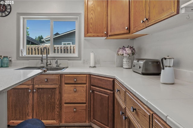 52396 SW 2nd St, Scappoose, OR 97056 - kitchen featuring a sink, light countertops, and brown cabinets