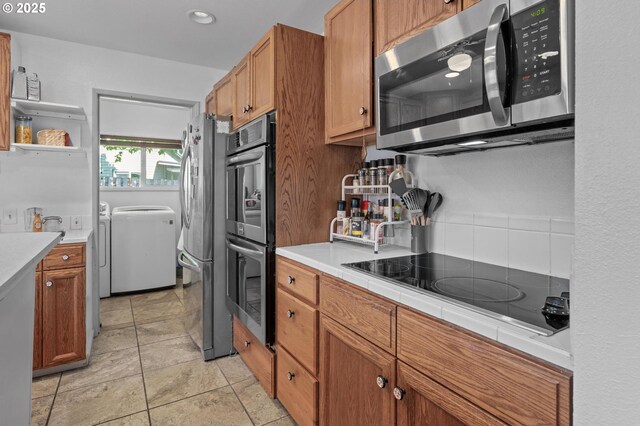 52396 SW 2nd St, Scappoose, OR 97056 - kitchen with appliances with stainless steel finishes, washing machine and dryer, brown cabinetry, recessed lighting, and open shelves