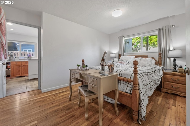 52396 SW 2nd St, Scappoose, OR 97056 - bedroom featuring light wood finished floors, baseboards, and a textured ceiling