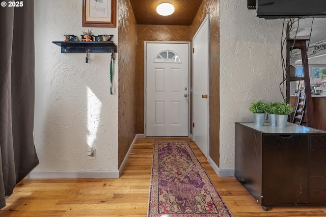 52396 SW 2nd St, Scappoose, OR 97056 - doorway featuring a textured wall, light wood-style flooring, and baseboards