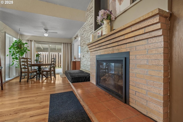 52396 SW 2nd St, Scappoose, OR 97056 - living room with wood finished floors, a ceiling fan, a fireplace, and healthy amount of natural light