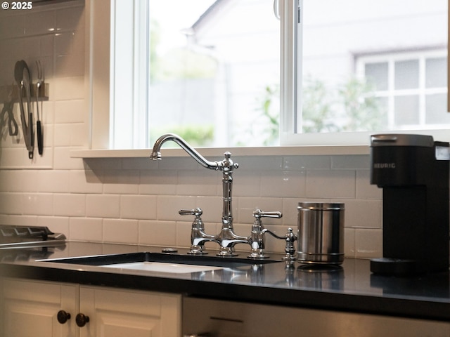 4415 SE Stark St, Portland, OR 97215 - kitchen view of tasteful backsplash, dark countertops, and white cabinets