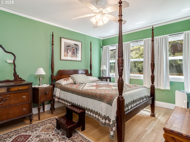 4415 SE Stark St, Portland, OR 97215 - bedroom with light wood-type flooring, ornamental molding, and a ceiling fan