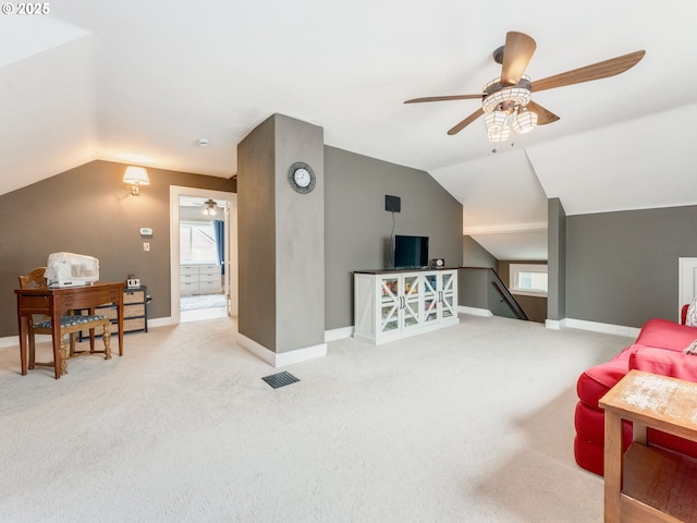 living area featuring ceiling fan, vaulted ceiling, carpet flooring, and baseboards