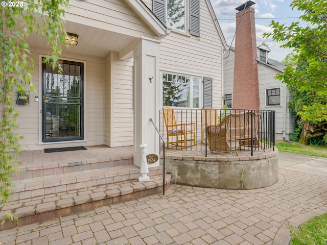 doorway to property featuring a patio area and covered porch