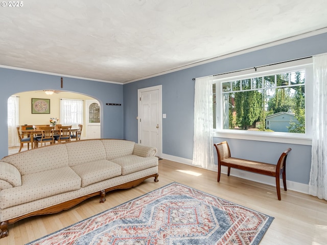 4415 SE Stark St, Portland, OR 97215 - living area featuring arched walkways, wood finished floors, and crown molding