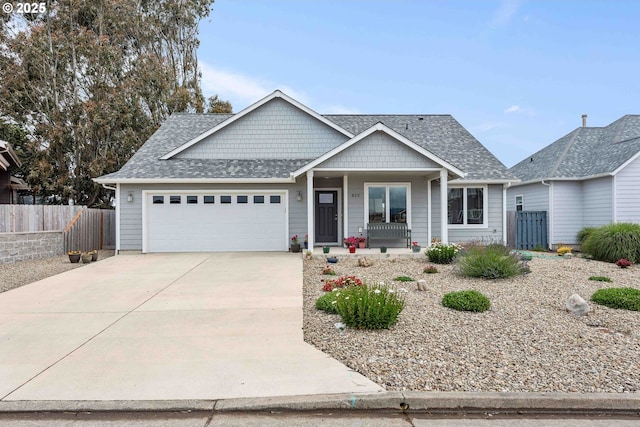822 Spyglass Dr, Bandon, OR 97411 - view of front of home featuring covered porch, a garage, driveway, and a shingled roof