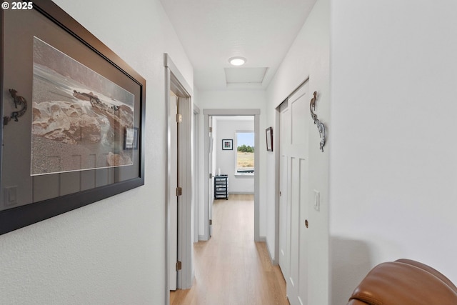 822 Spyglass Dr, Bandon, OR 97411 - corridor featuring light wood-style flooring and attic access