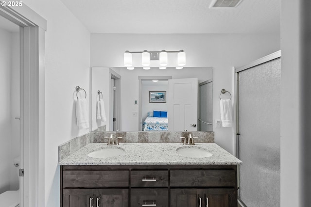 822 Spyglass Dr, Bandon, OR 97411 - full bathroom with double vanity, connected bathroom, and a shower stall