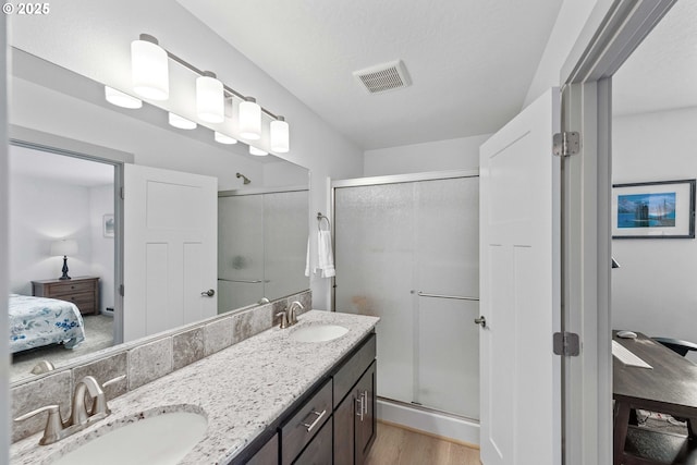 822 Spyglass Dr, Bandon, OR 97411 - ensuite bathroom with wood finished floors, a shower stall, and double vanity