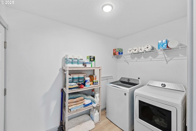 822 Spyglass Dr, Bandon, OR 97411 - washroom with washing machine and dryer and light wood-style flooring
