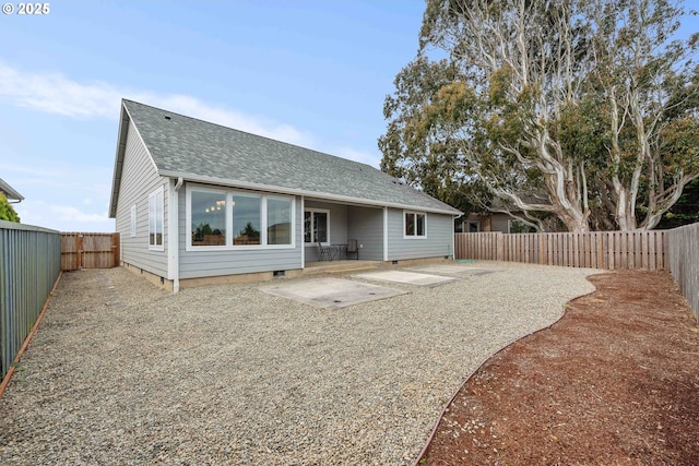 822 Spyglass Dr, Bandon, OR 97411 - rear view of house featuring a patio, a shingled roof, a fenced backyard, and crawl space