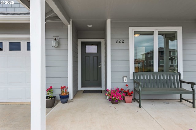 822 Spyglass Dr, Bandon, OR 97411 - view of exterior entry featuring covered porch and a garage